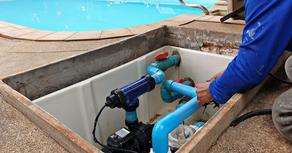 Man repairing and maintaining pipes for swimming pool - Precision Pools